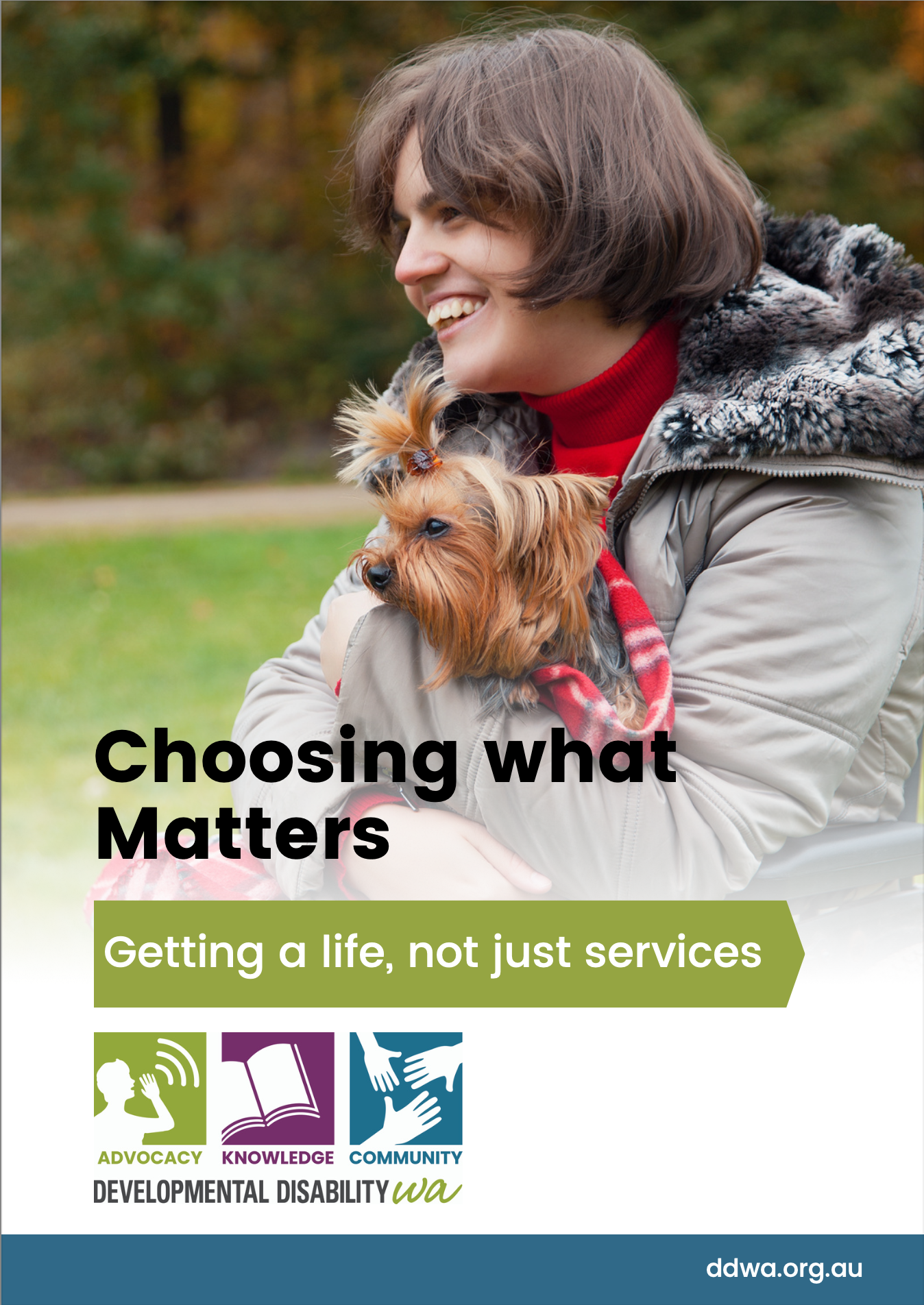 picture of woman in a wheelchair cuddling a Scottish terrier dog