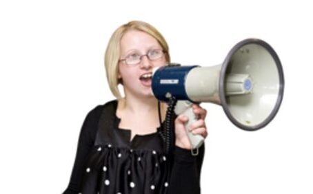 woman with intellectual disability holding megaphone up to her mouth to be heard loud and clear, symbolising self advocacy for her rights.