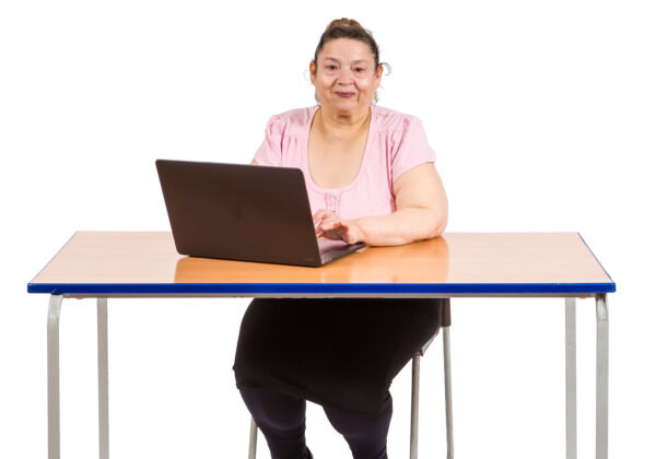 woman sitting at a desk with a computer laptop