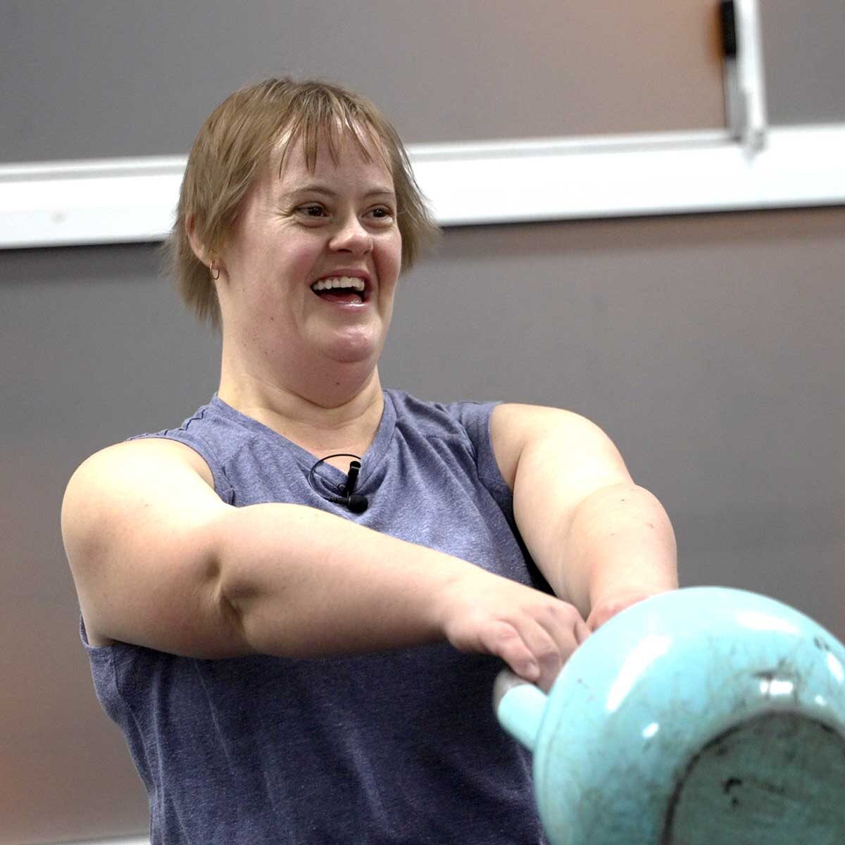 Young woman doing kettle bell workout
