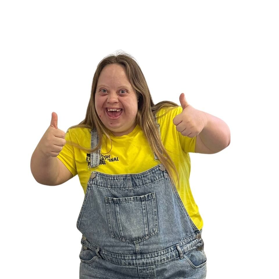 Young adult smiling with her thumbs up
