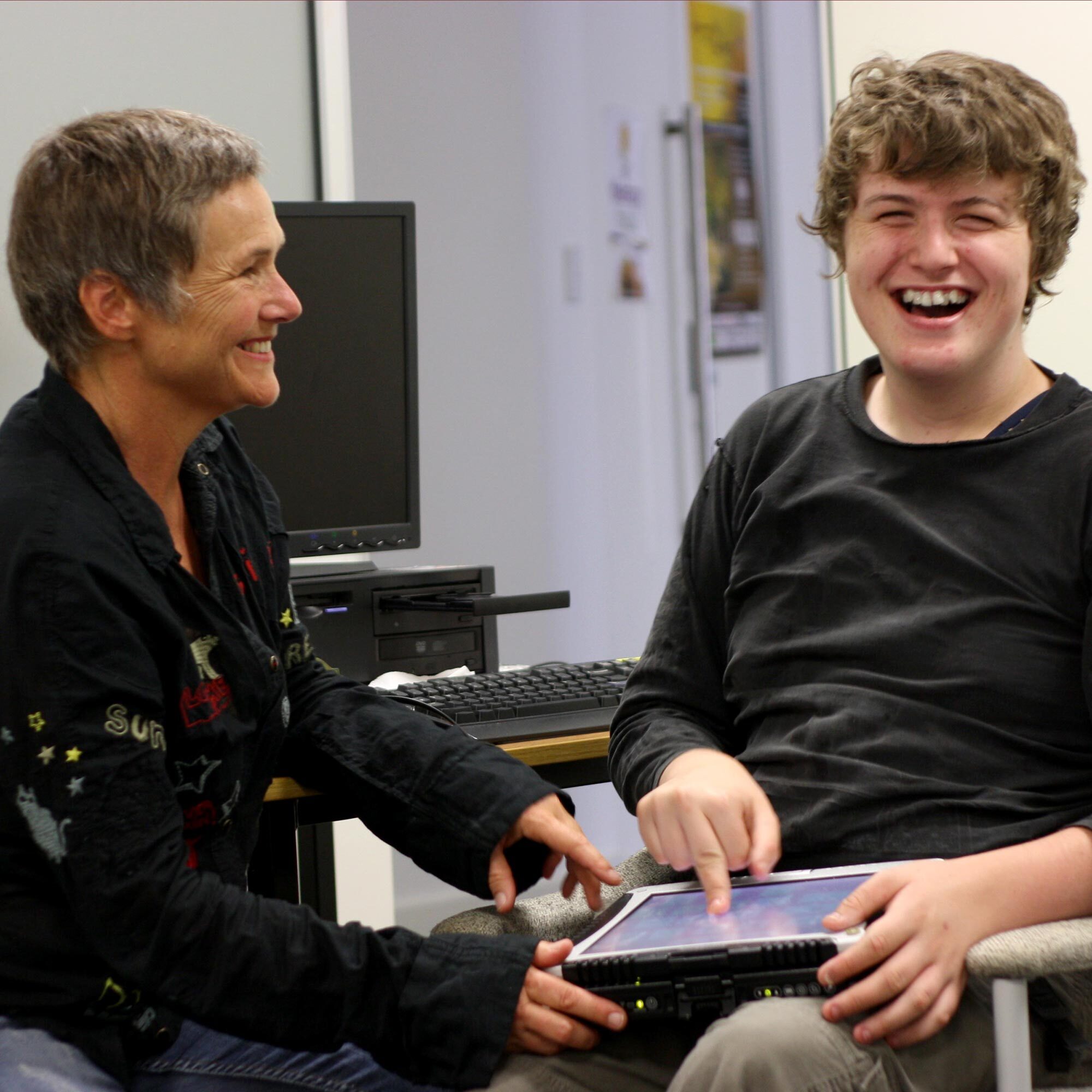 Eli and Gill in an office laughing