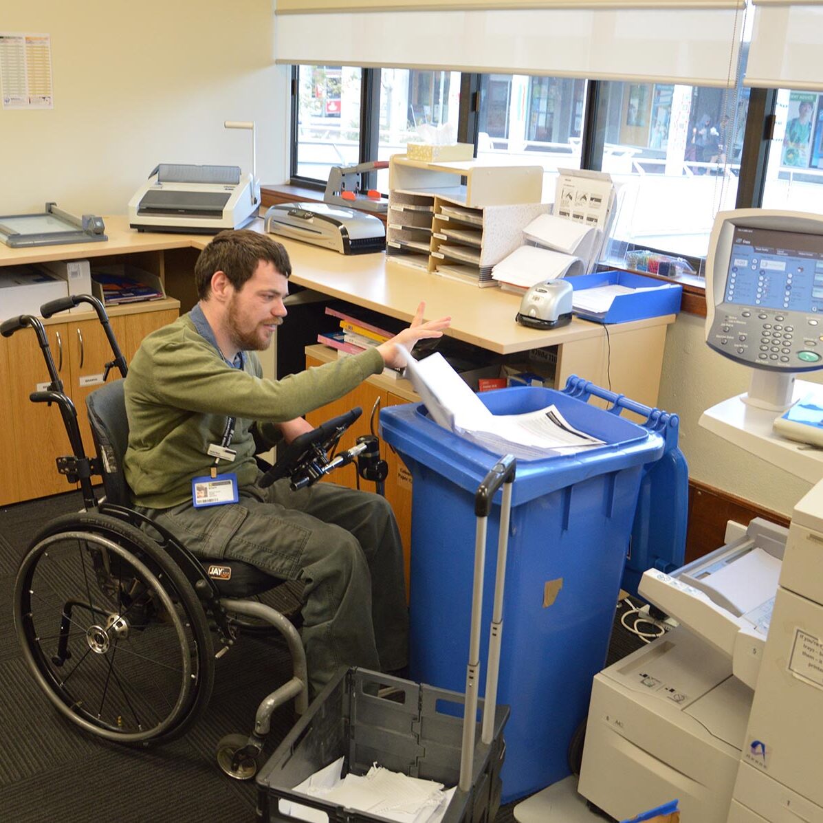 Man in a wheelchair working in a office