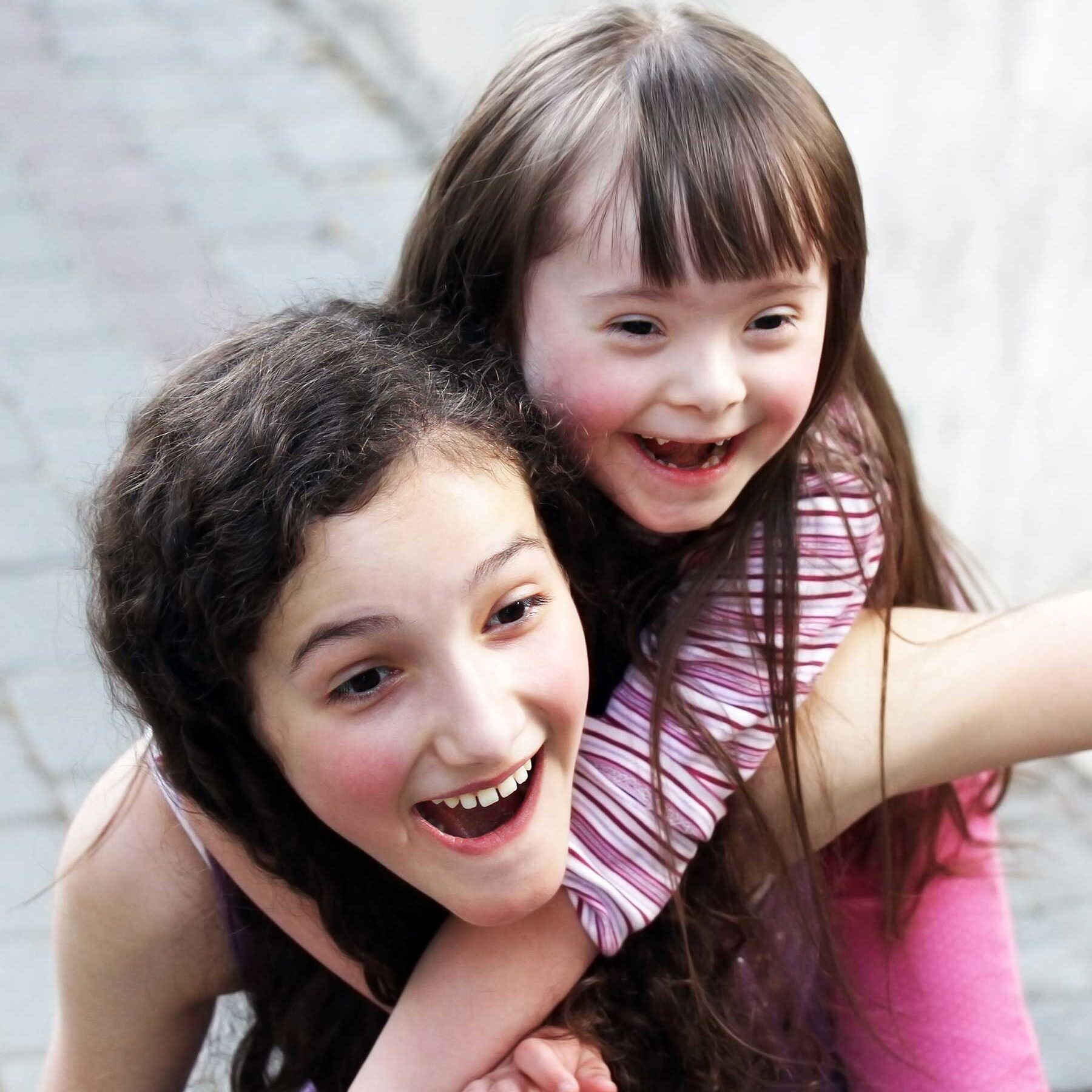 Two girls, one with Downs syndrome, playing